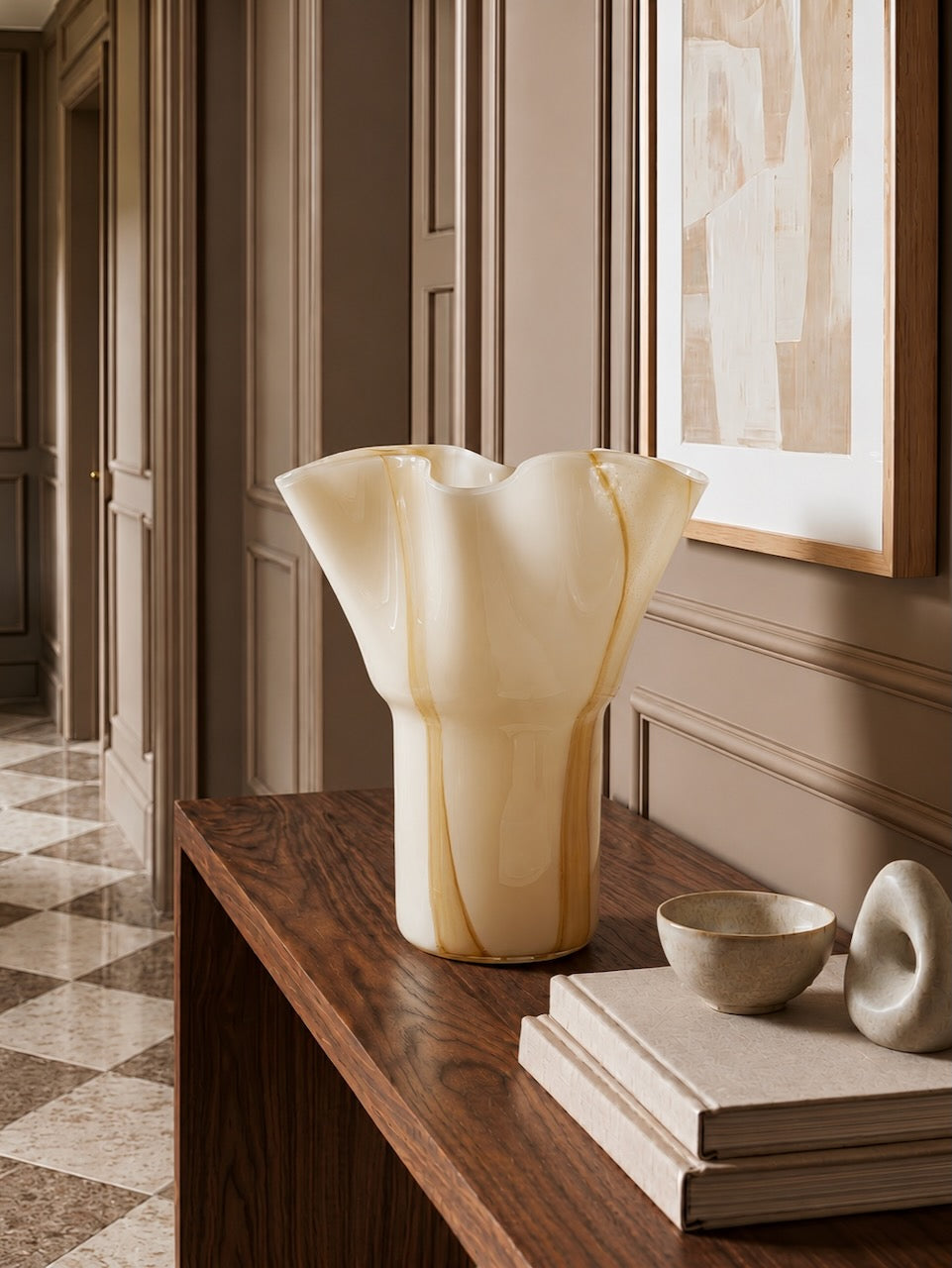 Decorative vase on a wooden surface with a neutral color palette