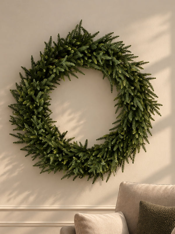 A full faux fir wreath on a warm neutral wall
