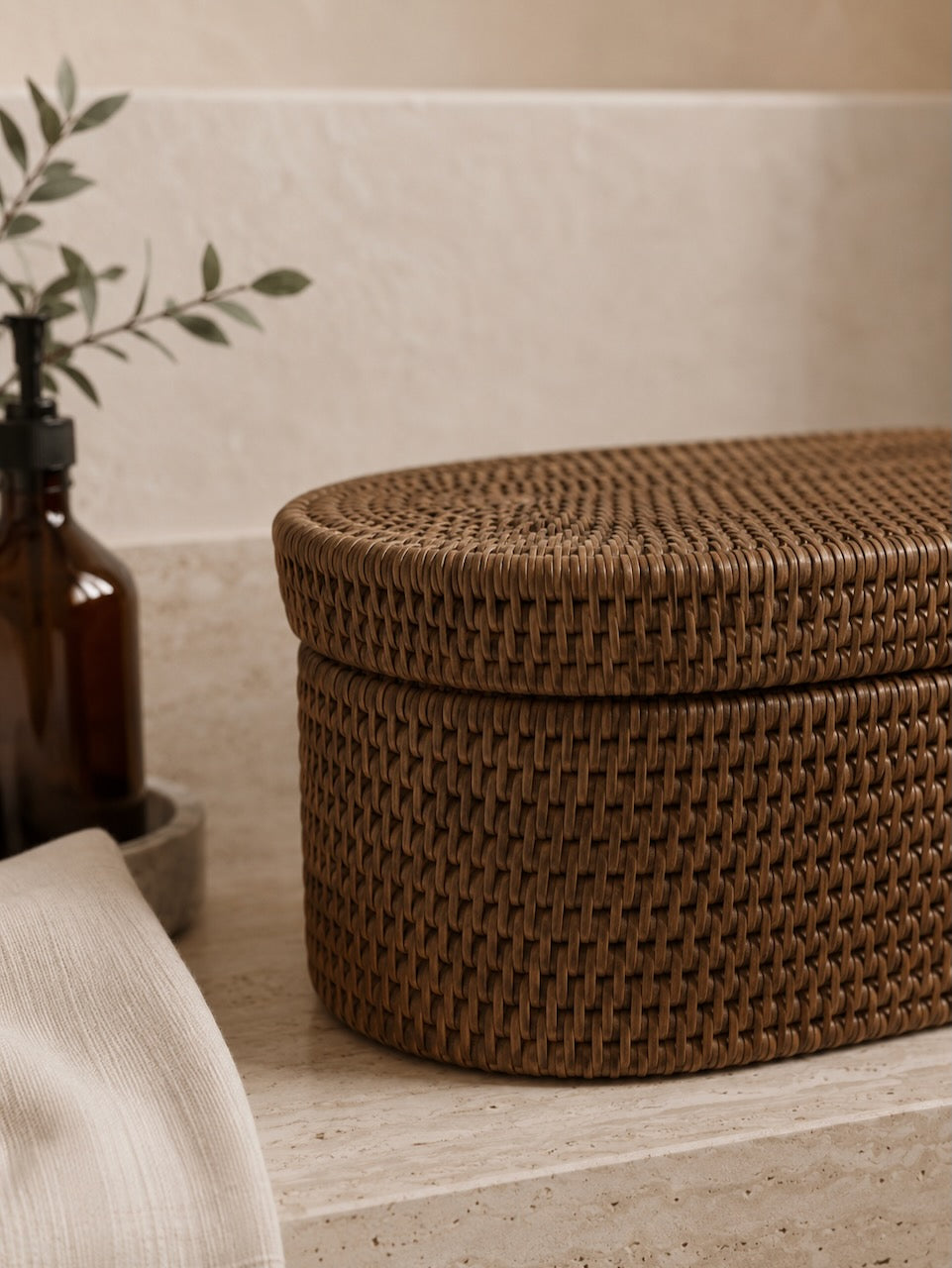 Jarra rattan Brown storage box on a light stone surface with a neutral background