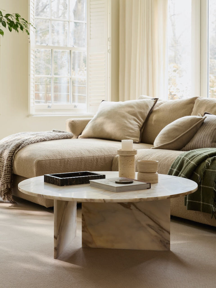 Beige sofa with a coffee table in a bright living room