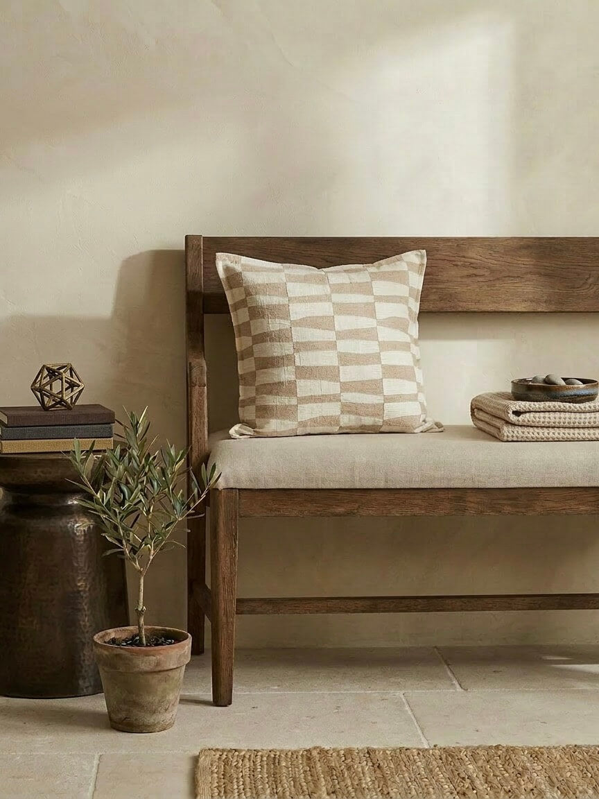 Caramel pattern cushion cover 50x50 cm with neutral checkered design on a wooden bench, styled with earthy decor and soft beige tones