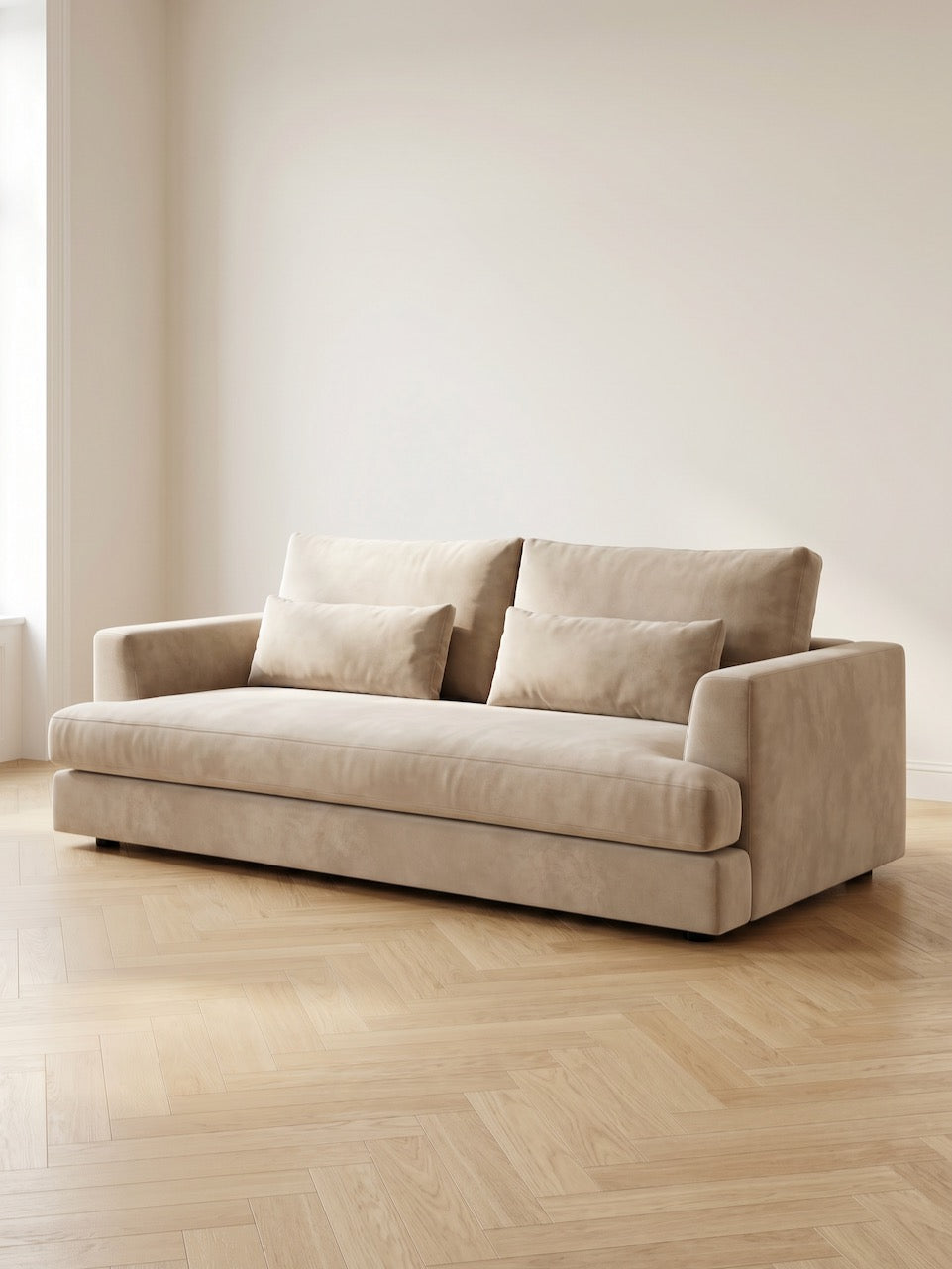 Beige sofa in a room with light wood flooring and white walls